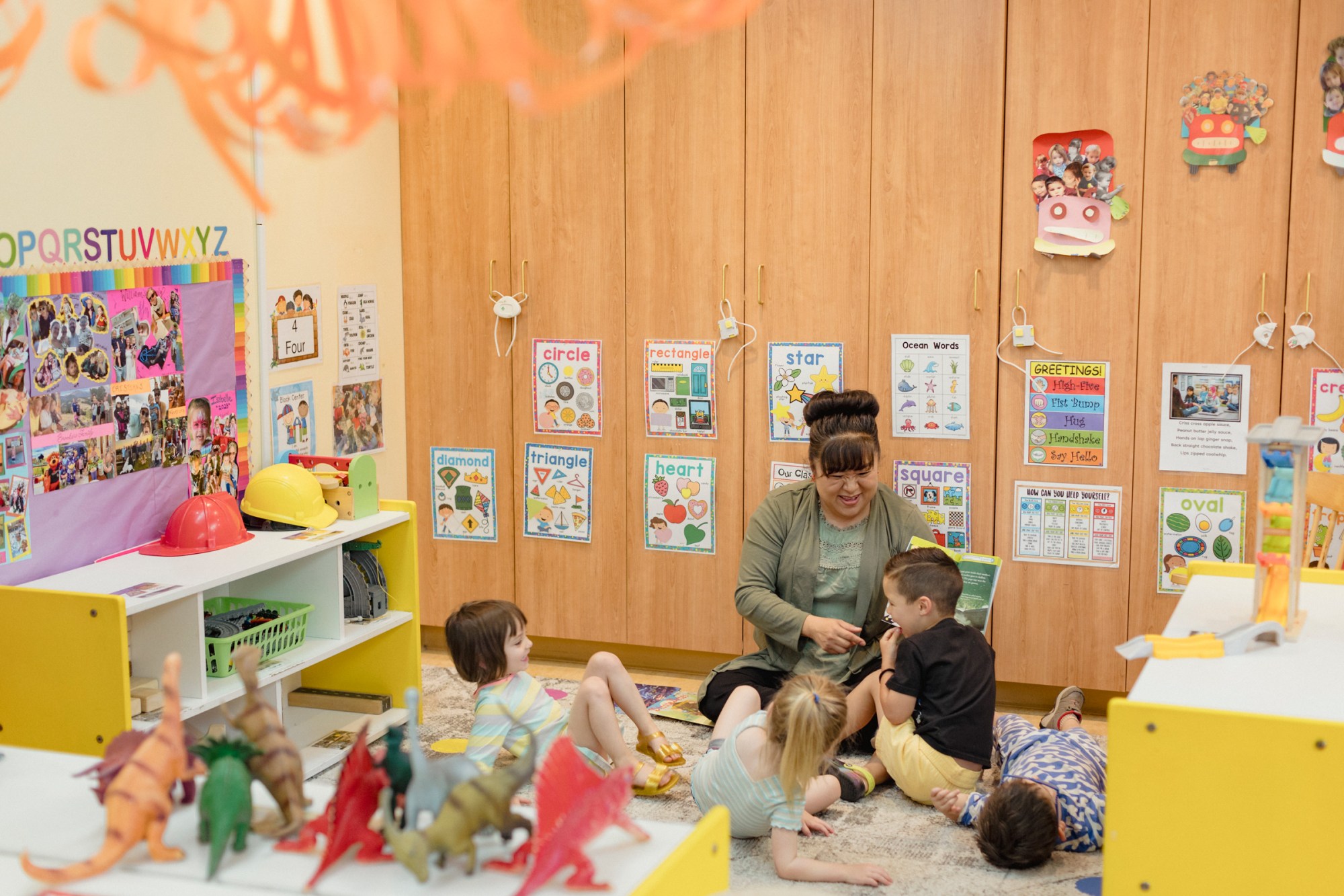 Teacher Sabrina Moquino works with students during circle time in a pre-K class at the First Presbyterian Church of Santa Fe’s Child Development Center in Santa Fe, New Mexico. With the new state child-care program, the center no longer has to cap the number of students that receive subsidies.