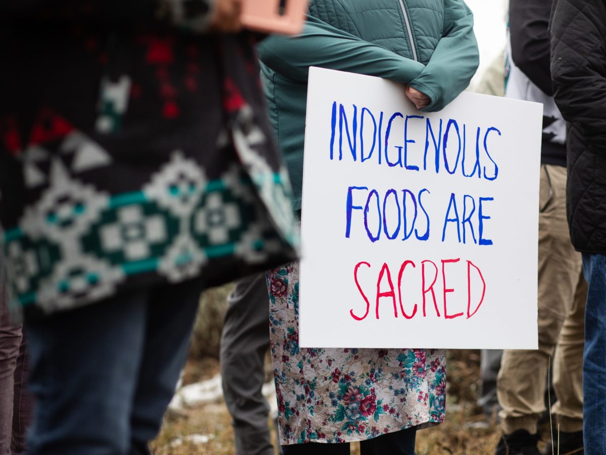 Sonya Schaller, a supporter from Omak, Washington, holds a sign during a gathering on Badger Mountain in East Wenatchee, Washington.