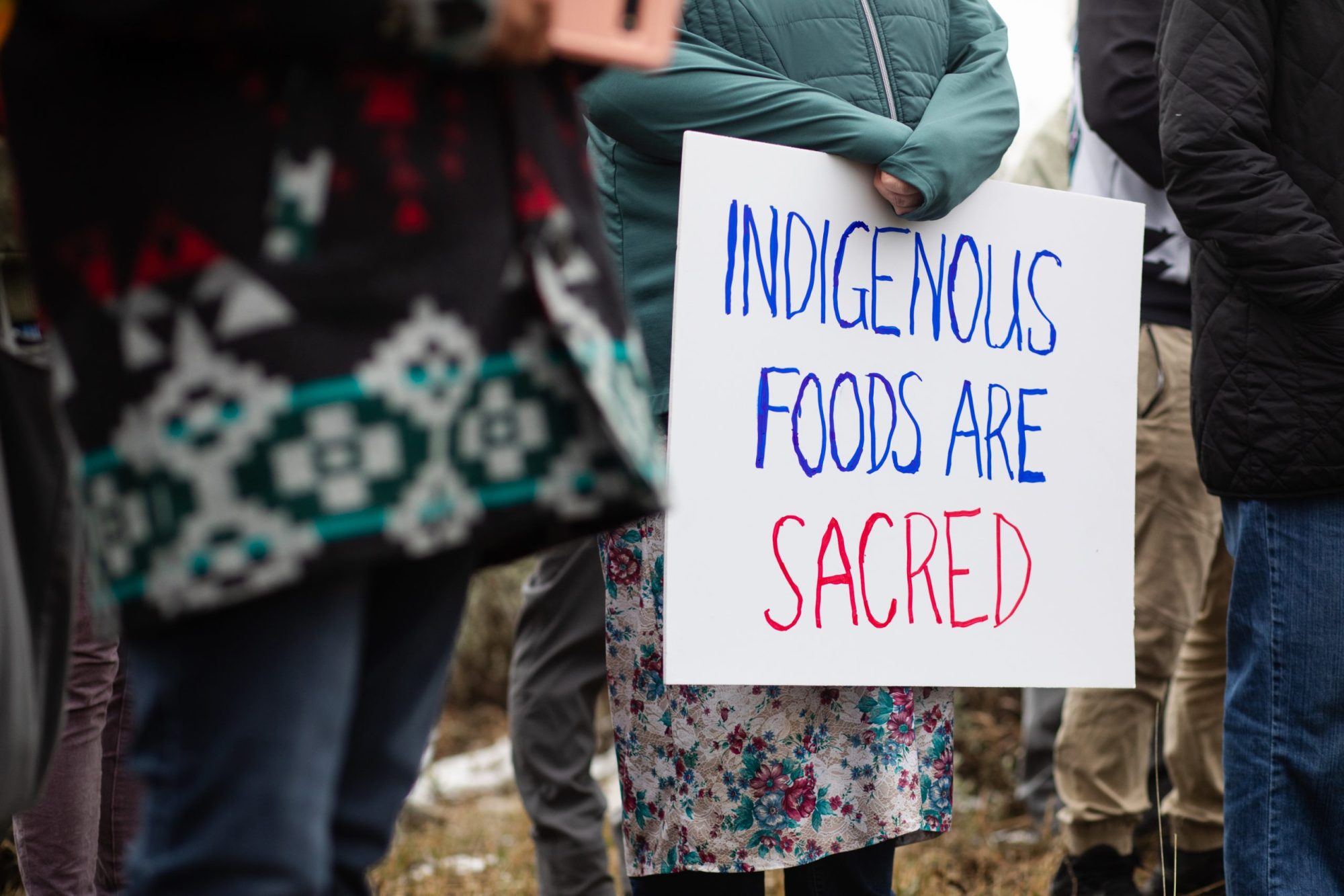 Sonya Schaller, a supporter from Omak, Washington, holds a sign during a gathering on Badger Mountain in East Wenatchee, Washington.