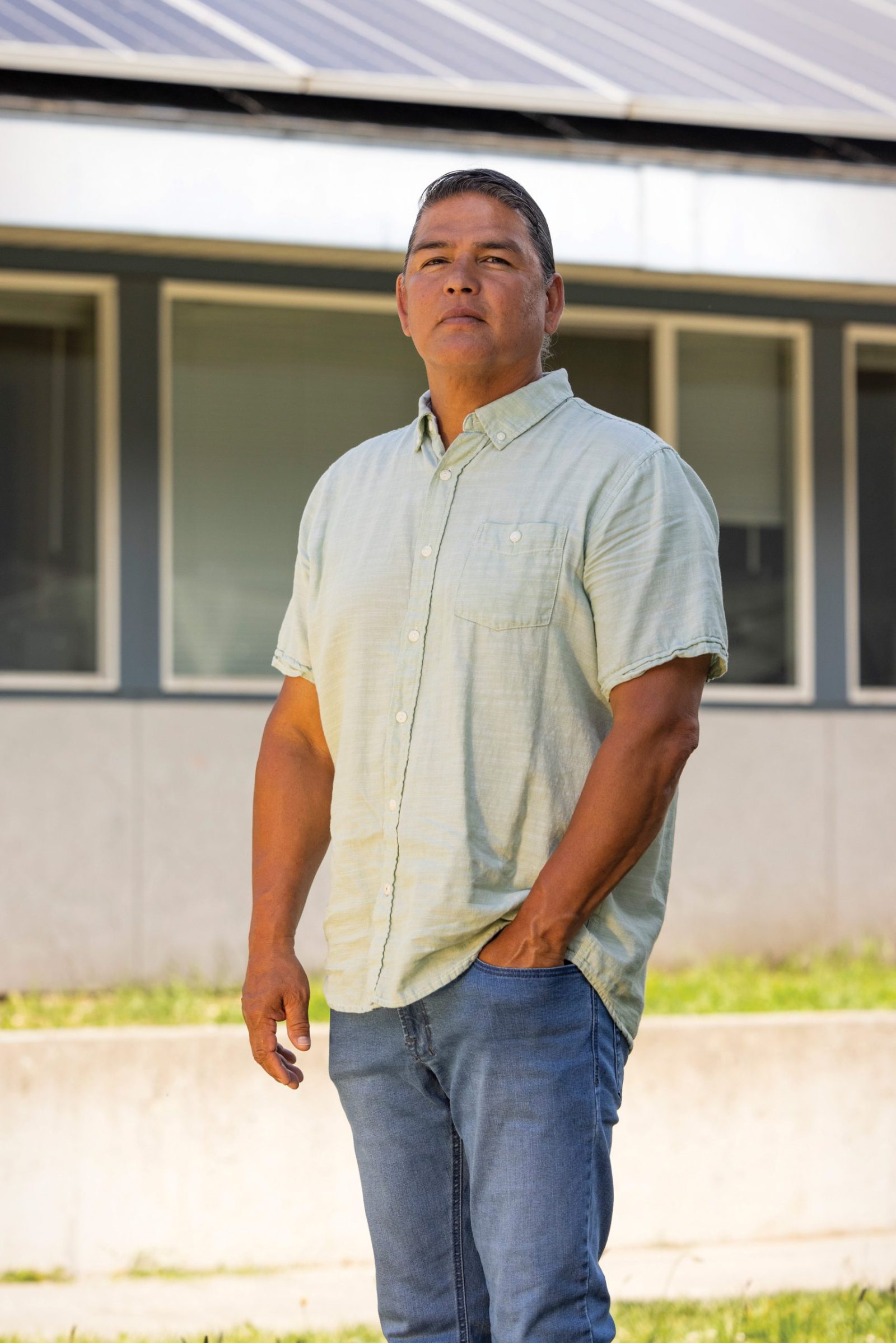 Basil George in front of solar panels his crew installed in Lapwai.