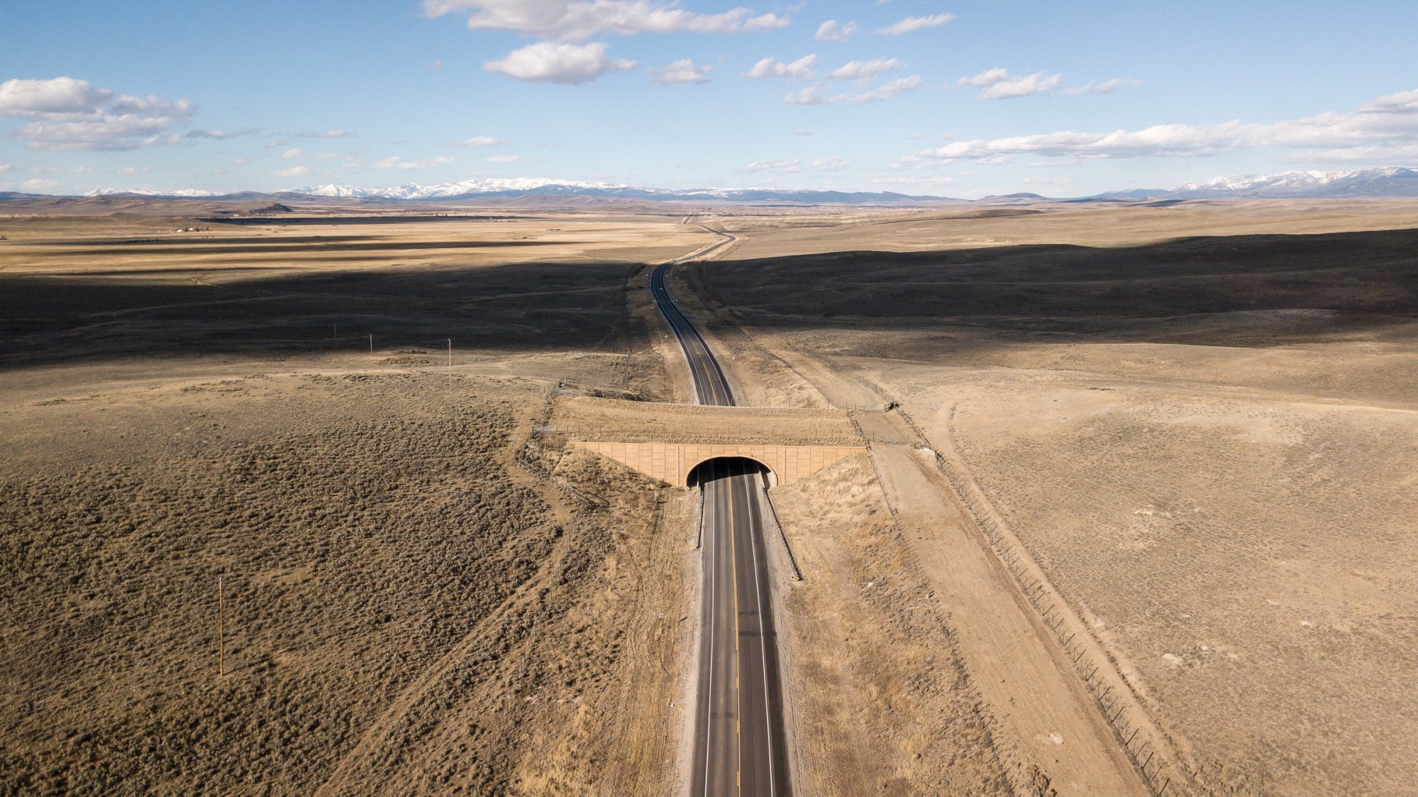 Roughly 5 miles separate the wildlife overpass just north of Daniel Junction, pictured, from the Trappers Point overpass outside Pinedale, Wyoming. Overpasses like these, along with underpasses and wildlife fences, have helped reduce wildife-vehicle collisions in the state by 80% to 90%, according to the Wyoming Game and Fish Department.